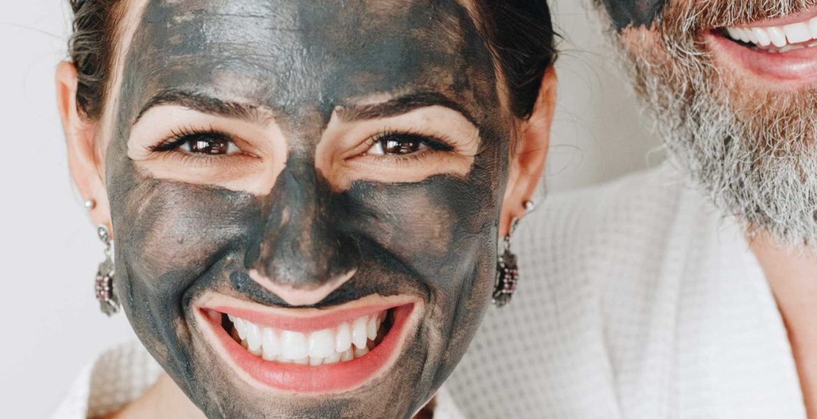 happy-couple-wearing-a-charcoal-mask-AXYBWQ9-scaled.jpg